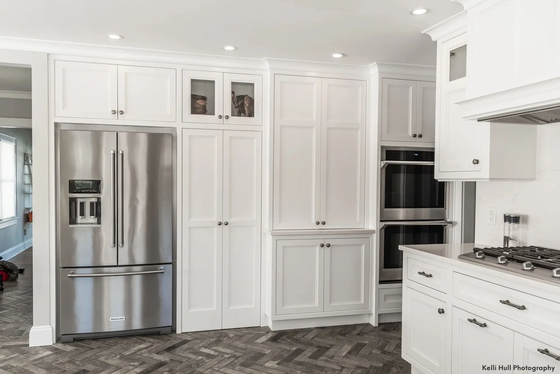 white pantry wall around stainless refrigerator, Kitchens & Vanities